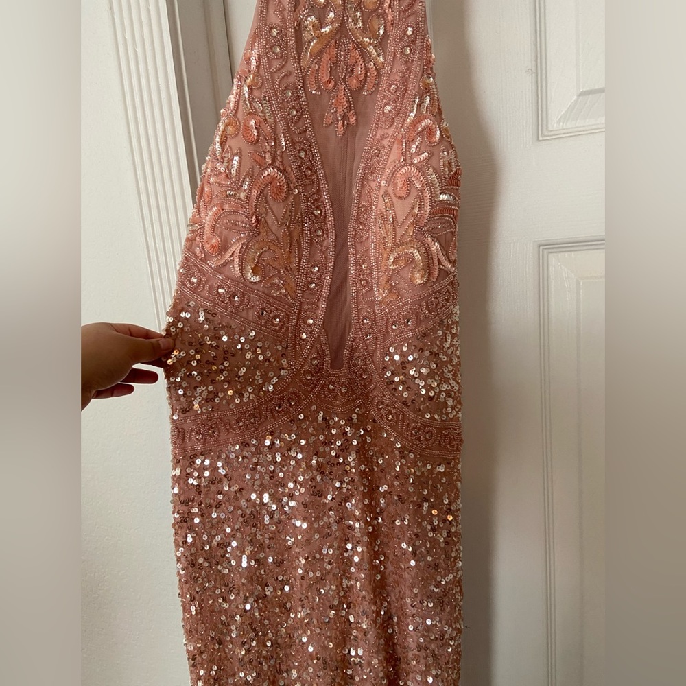The dress is a tannish pink and NEVER BEEN WORN!!!